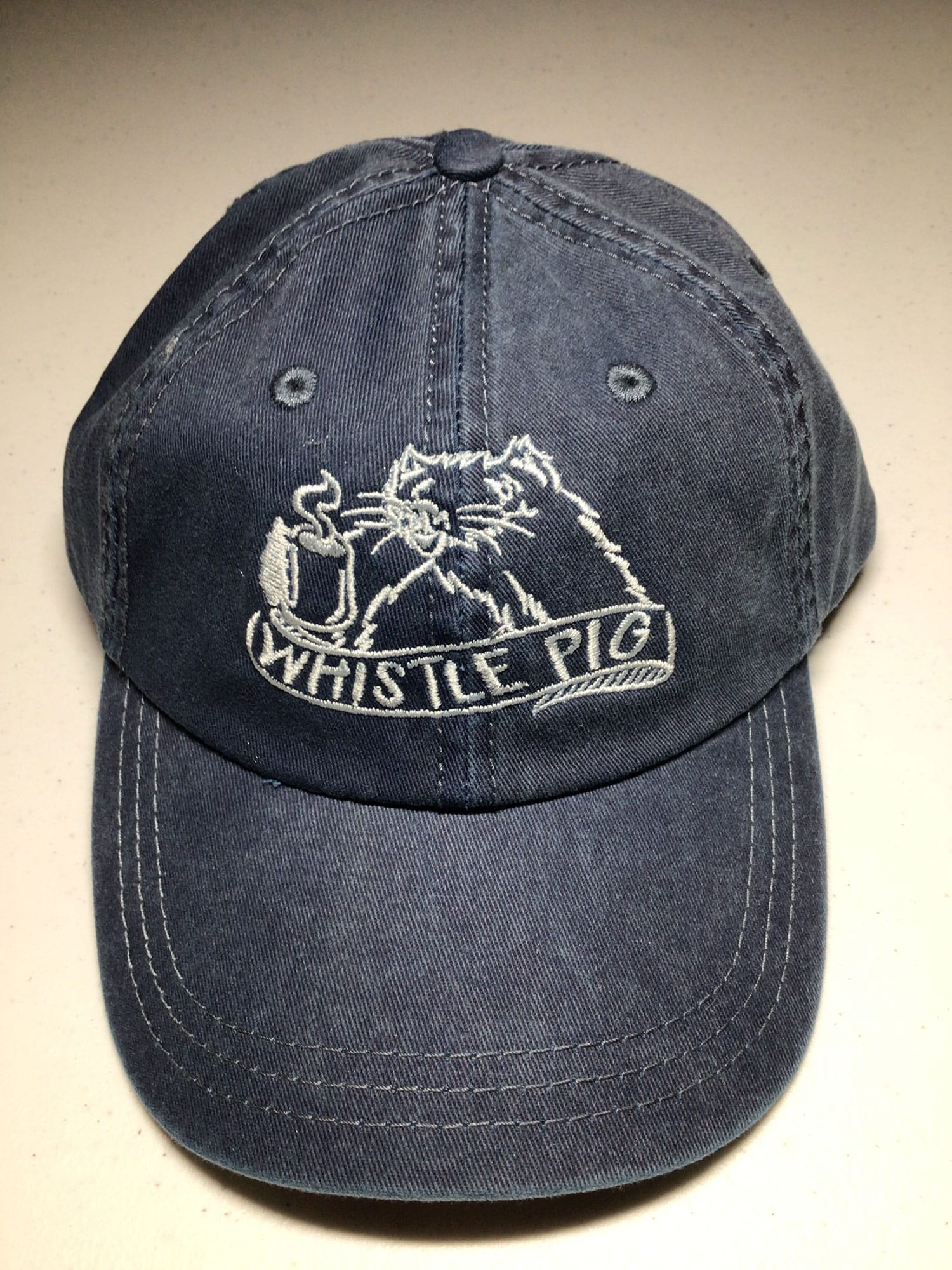 Black baseball cap with sewn Whistle Pig logo in white on the crown.